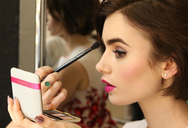 Lily Collins applying makeup