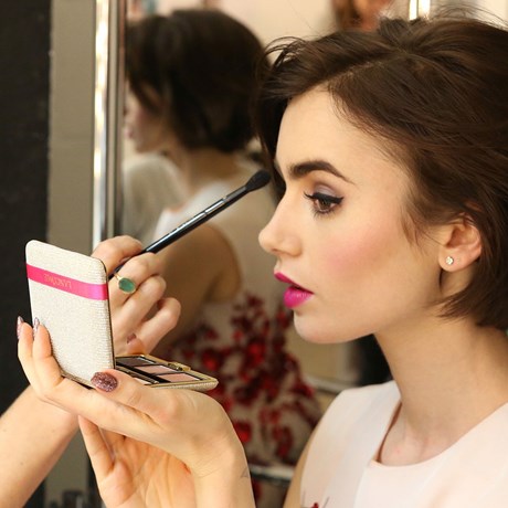 Lily Collins applying makeup